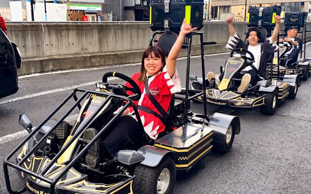 Participants enjoying a Street Kart experience in Tokyo, driving go-karts on city streets.