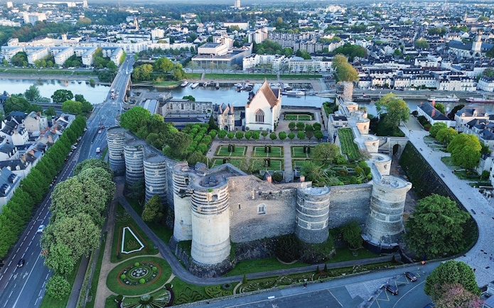 Aerial view of Angers Castle with gardens and surrounding cityscape in Angers, France.