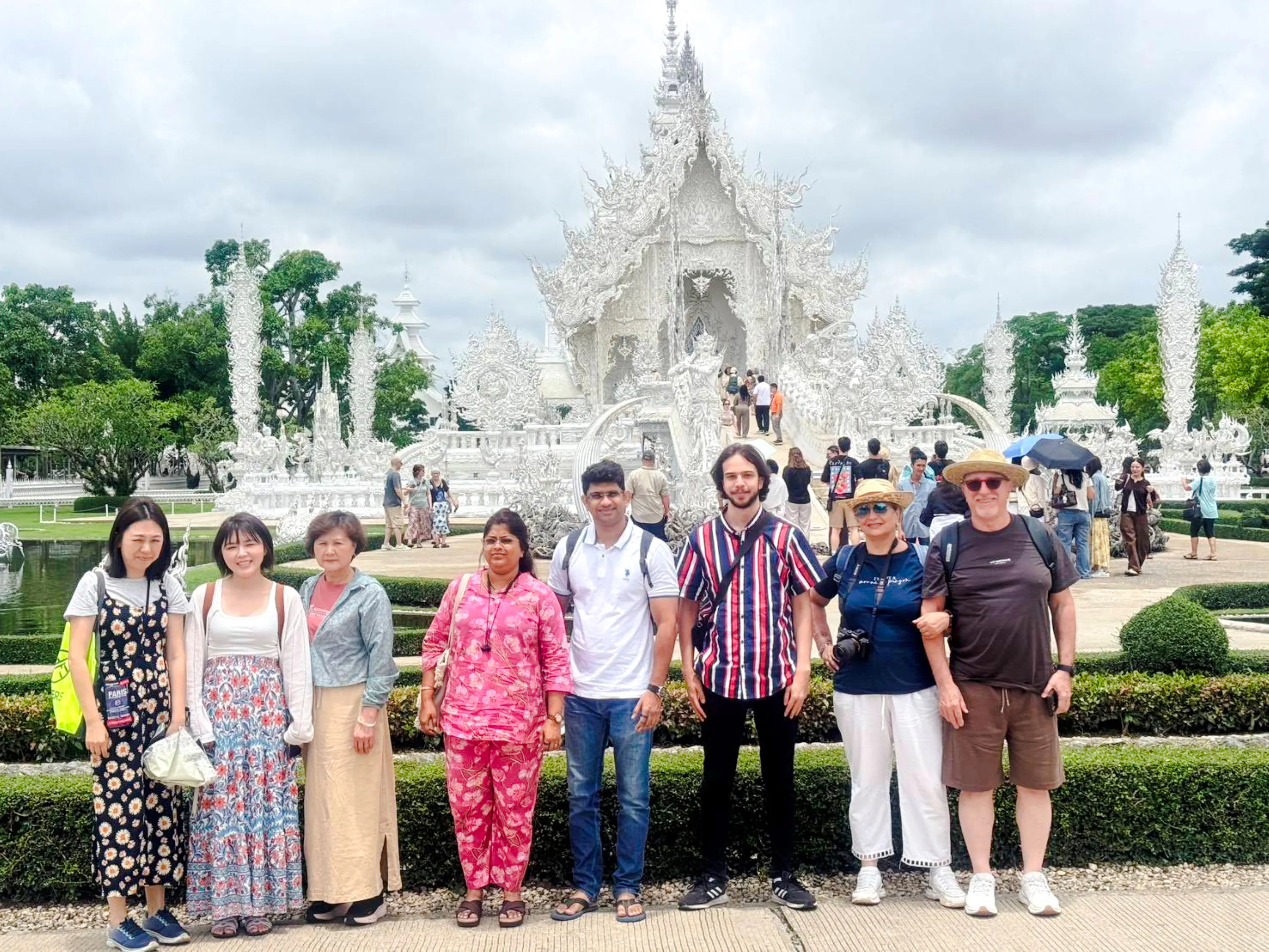 Visitors in front of the White Temple, Wat Rong Khun, Chiang Rai.
