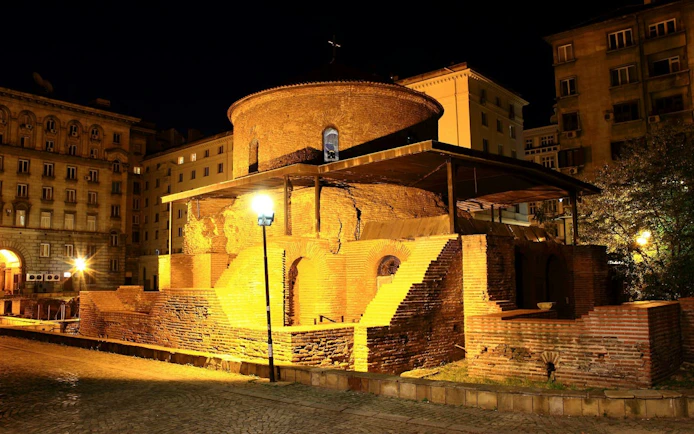 Rotunda of St. George in Sofia illuminated at night, part of Communist Sofia exploration game.