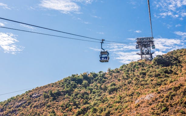 Ngong Ping Cable Car over lush hillside, Hong Kong.