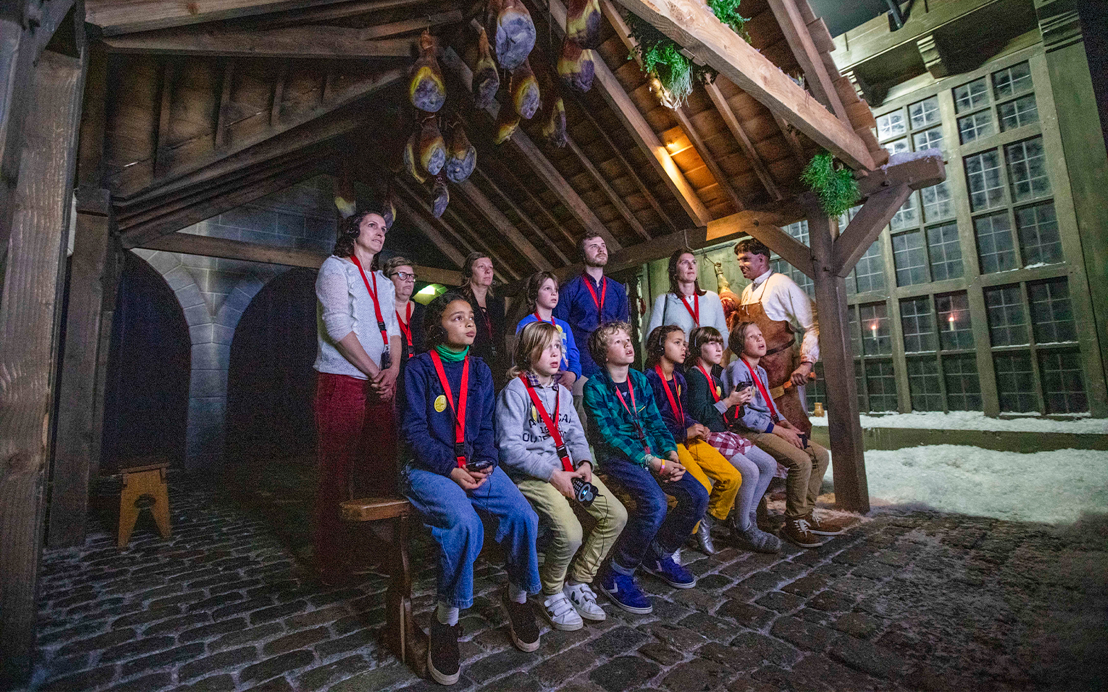 Guests watching a presentation at Historium Bruges under a wooden roof.