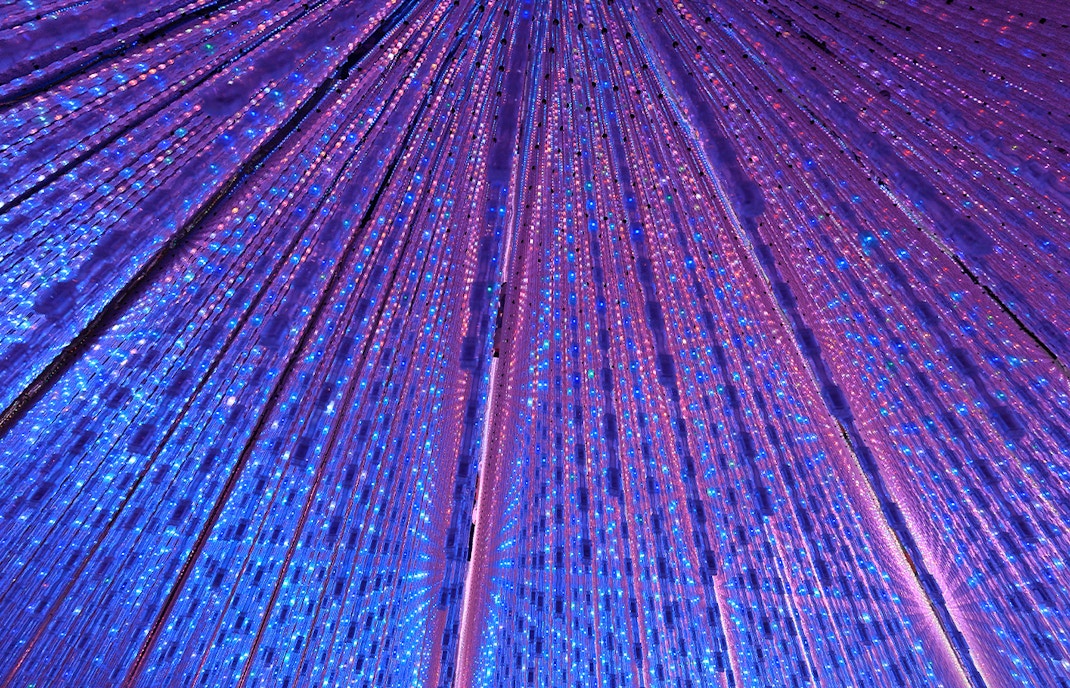 TeamLab Planets Tokyo immersive digital art installation with vibrant light displays.