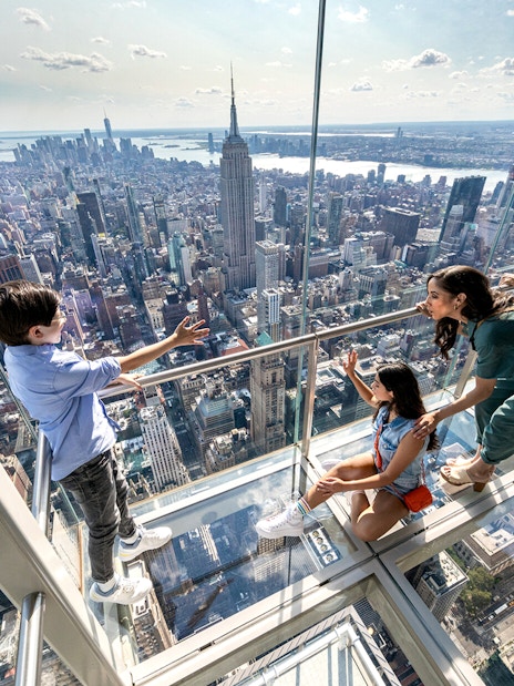 Visitors enjoying the view from the glass floor at SUMMIT One Vanderbilt, New York City.