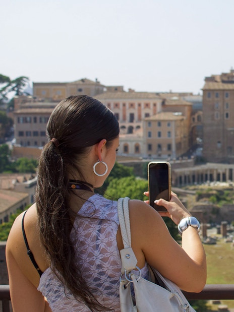 Couple viewing Roman Forum during guided tour in Rome.