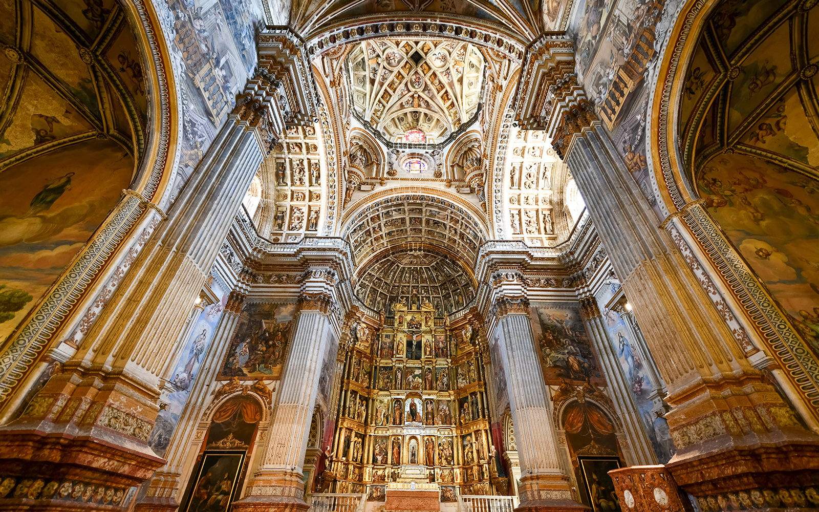 Granada Cathedral interior with ornate columns and detailed ceiling.