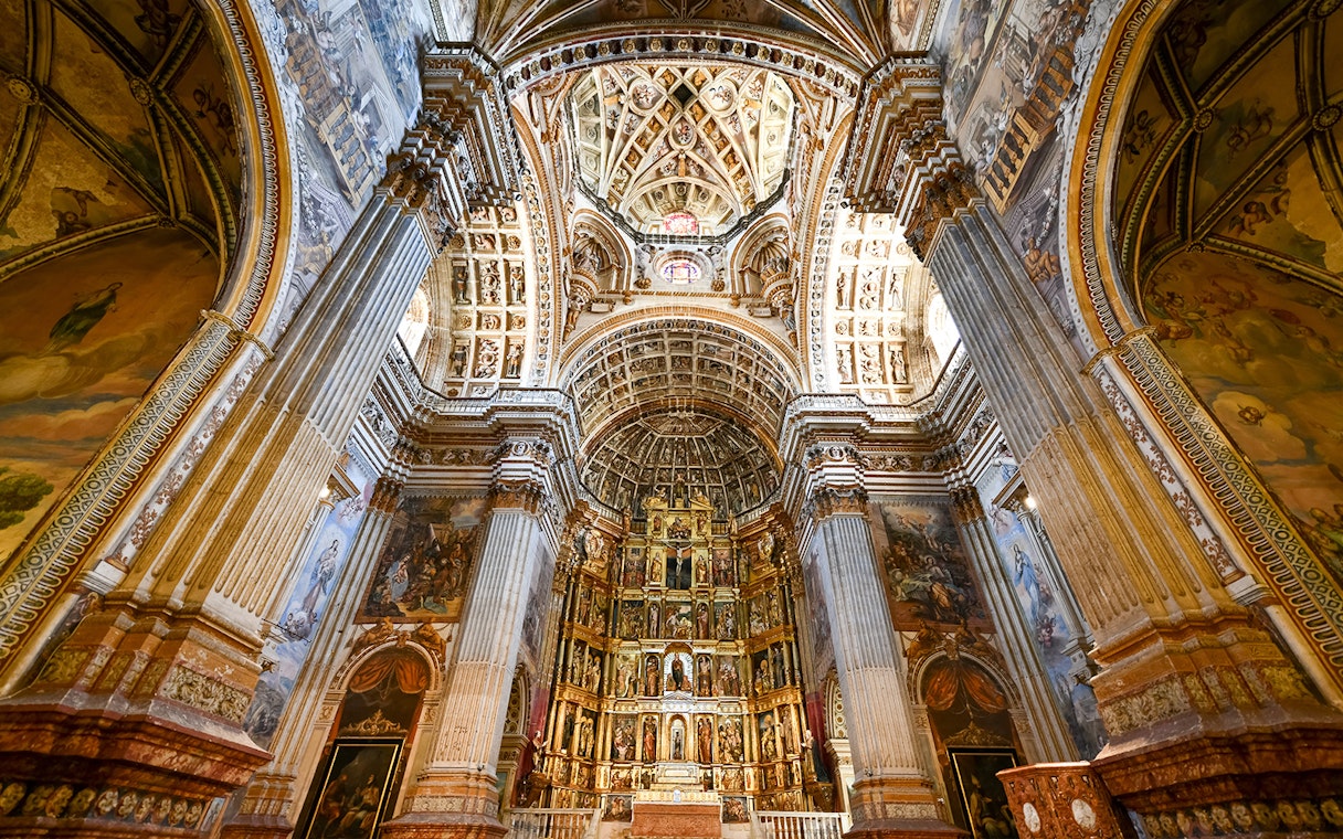Granada Cathedral interior with ornate columns and detailed ceiling.