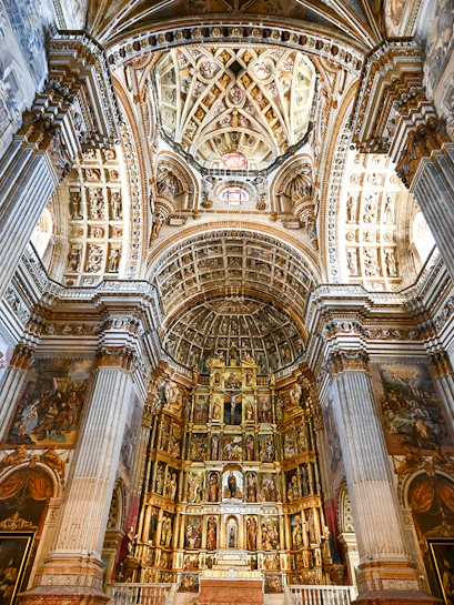 Granada Cathedral interior with ornate columns and detailed ceiling.