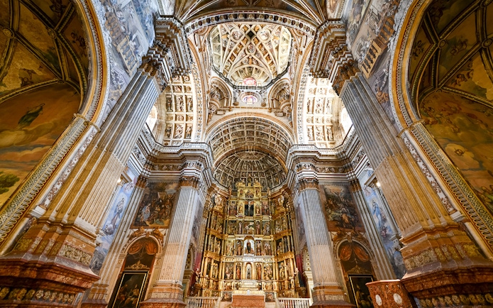 Granada Cathedral interior with ornate columns and detailed ceiling.