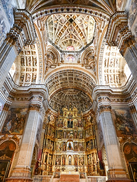 Granada Cathedral interior with ornate columns and detailed ceiling.