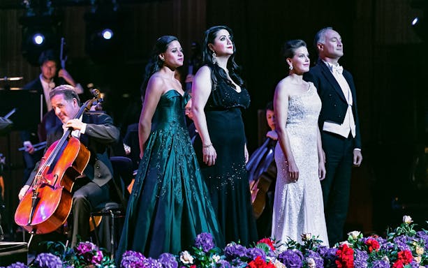 Performers on stage at NYE Opera Gala, Sydney Opera House, with musicians in the background.