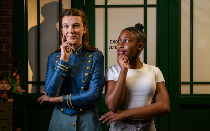 Enola Holmes wax figure with visitor at Madame Tussauds London.