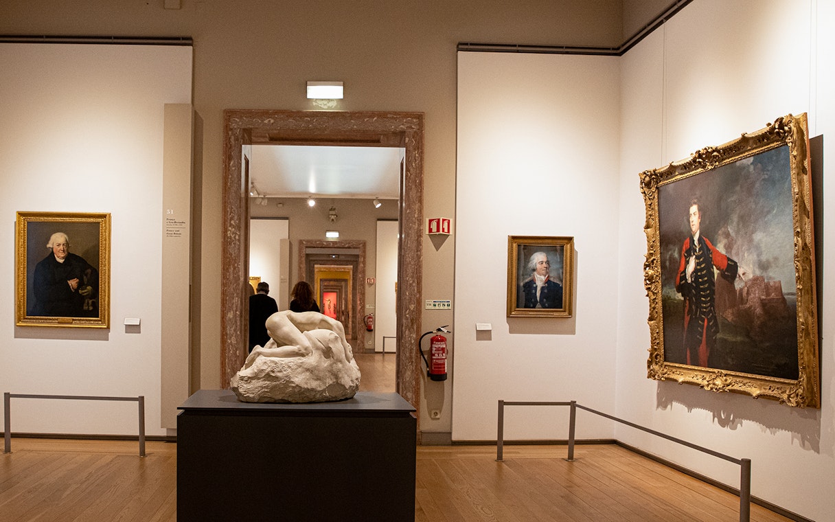 Art gallery with classical paintings and sculptures at the National Museum of Ancient Art.
