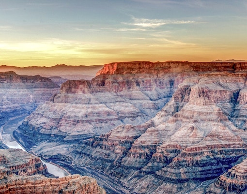 Tourists viewing the Grand Canyon West Rim from an observation point in Arizona.