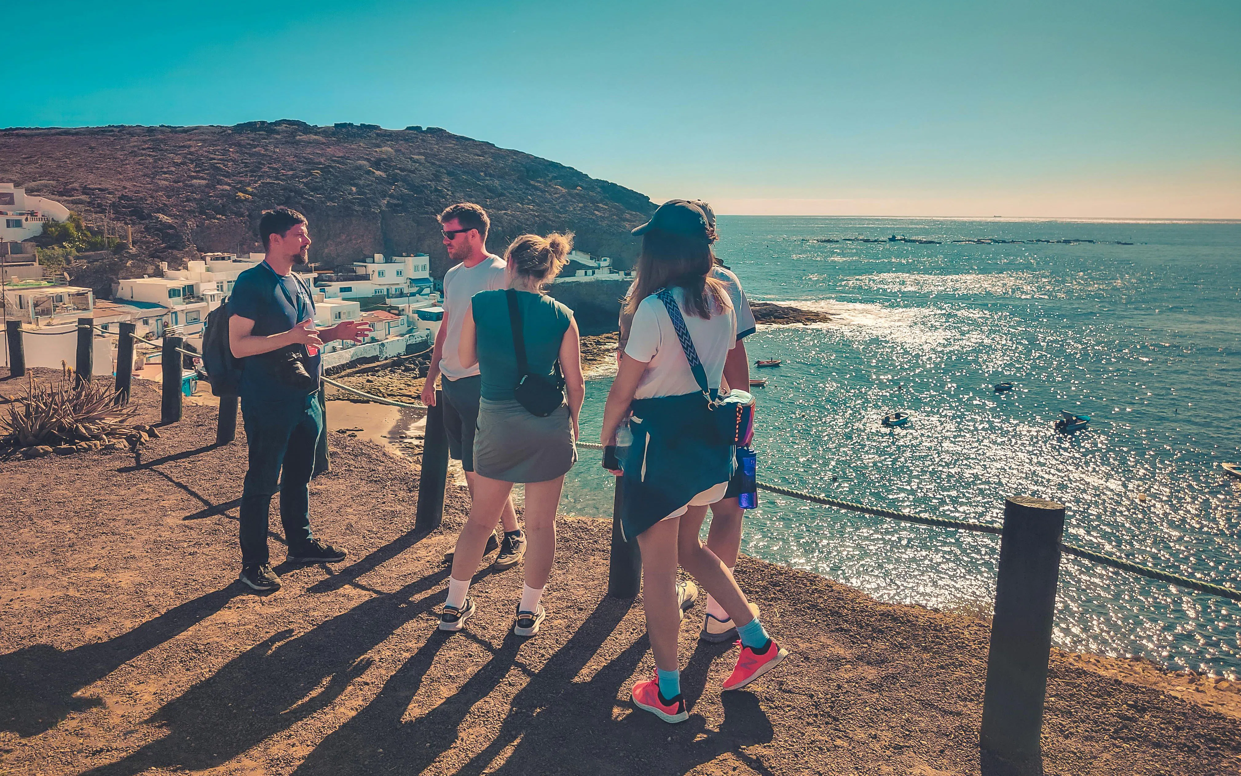 Group of tourists overlooking Playa del Confital during Red Canyon Tour.