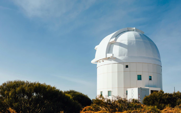 Teide Observatory telescope against blue sky in Tenerife, Canary Islands, Spain.