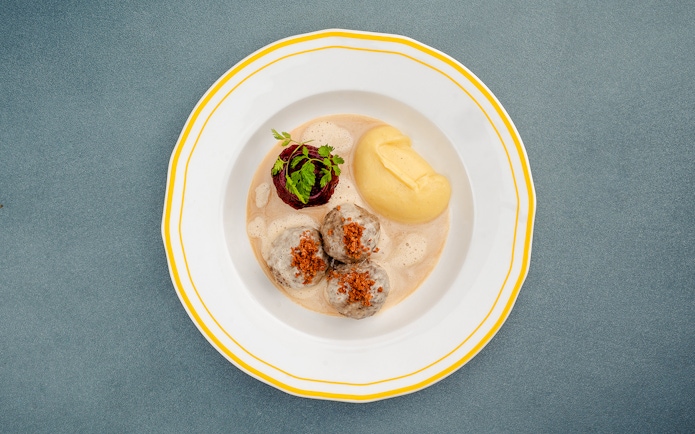 German meatballs with mashed potatoes and garnish, Berlin.