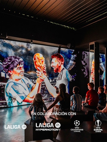 Visitors watching a football legends mural at Legends: The Home of Football Museum.