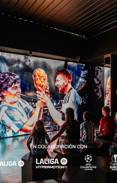 Visitors watching a football legends mural at Legends: The Home of Football Museum.