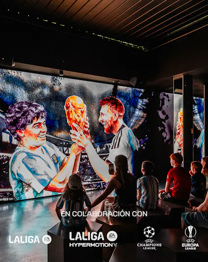 Visitors watching a football legends mural at Legends: The Home of Football Museum.