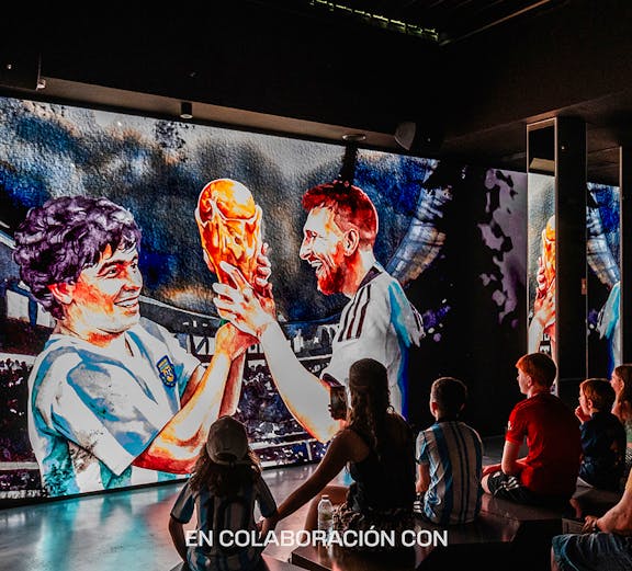 Visitors watching a football legends mural at Legends: The Home of Football Museum.