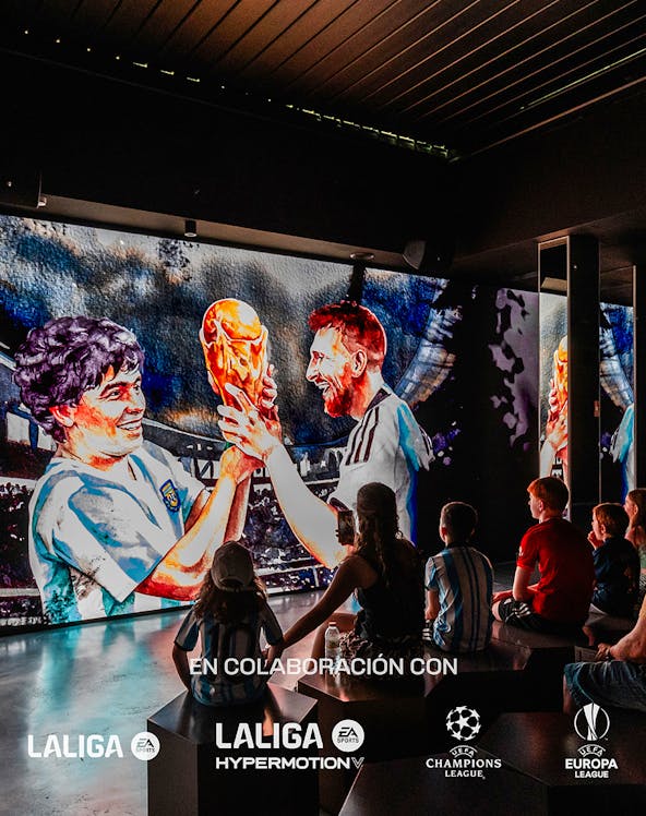 Visitors watching a football legends mural at Legends: The Home of Football Museum.
