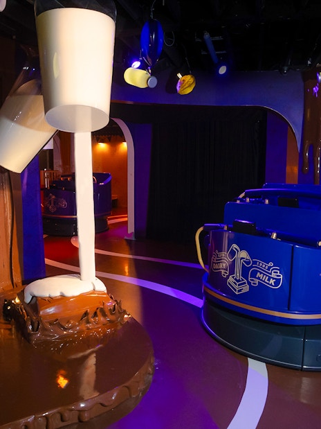 Cadbury World ride with chocolate-themed decor and milk pouring display.