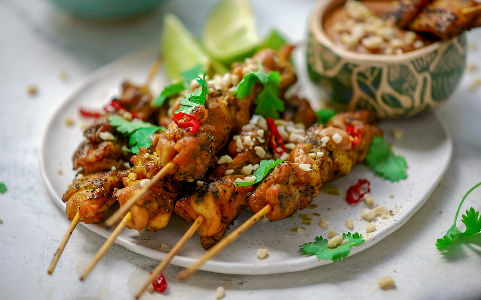 Chicken satay skewers with peanut sauce.