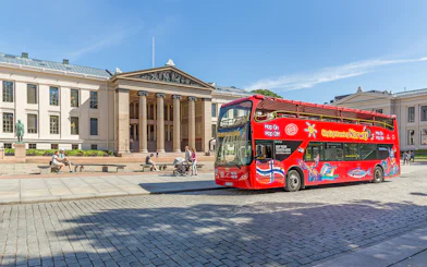 Red double-decker bus in front of Oslo University on a City Sightseeing Hop-On Hop-Off tour.