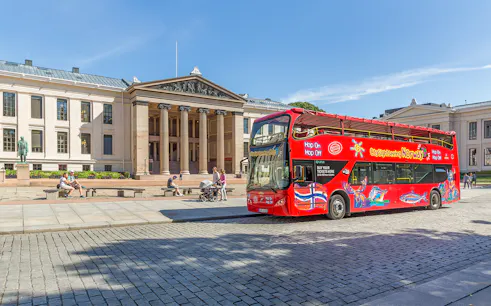 Red double-decker bus in front of Oslo University on a City Sightseeing Hop-On Hop-Off tour.