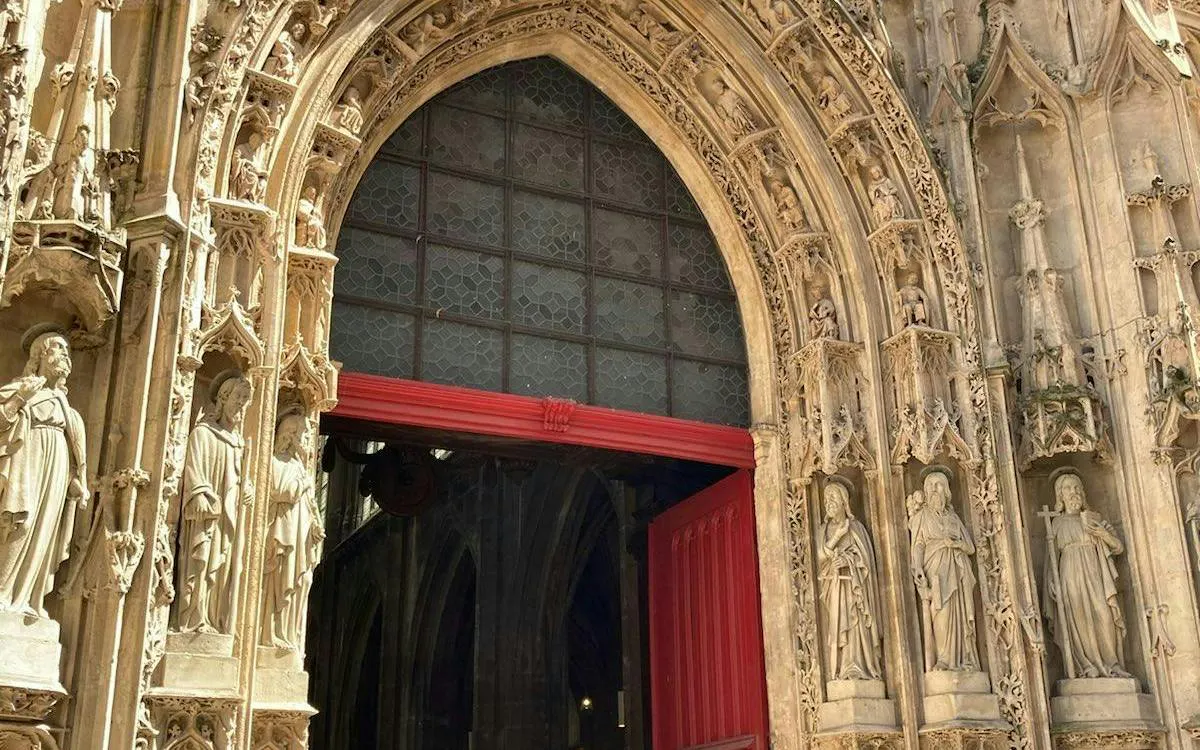 Gothic cathedral entrance with detailed stone carvings, Paris.