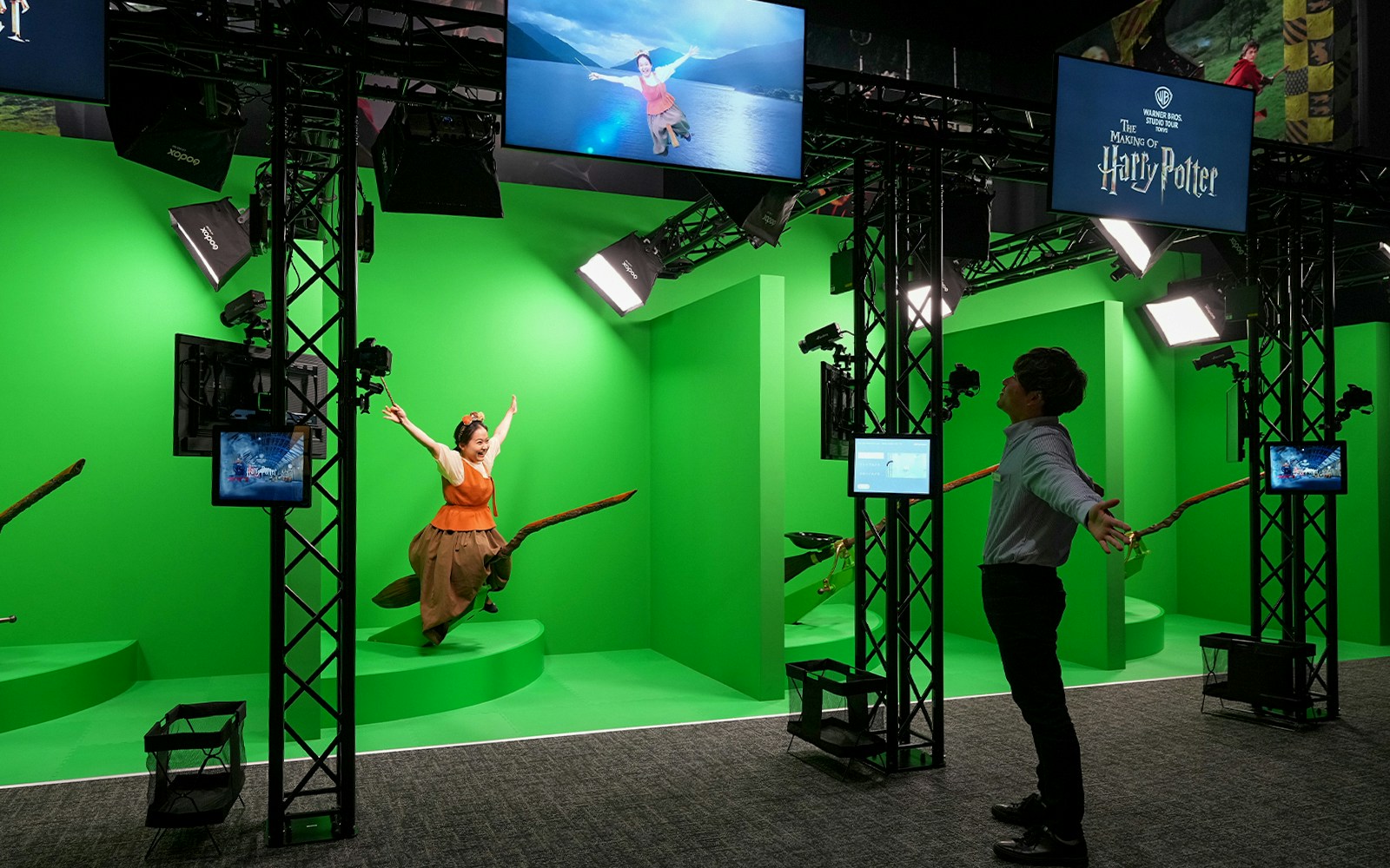 Visitors exploring Quidditch exhibit at Warner Bros. Studio Tour Tokyo, featuring broomsticks and golden snitch.