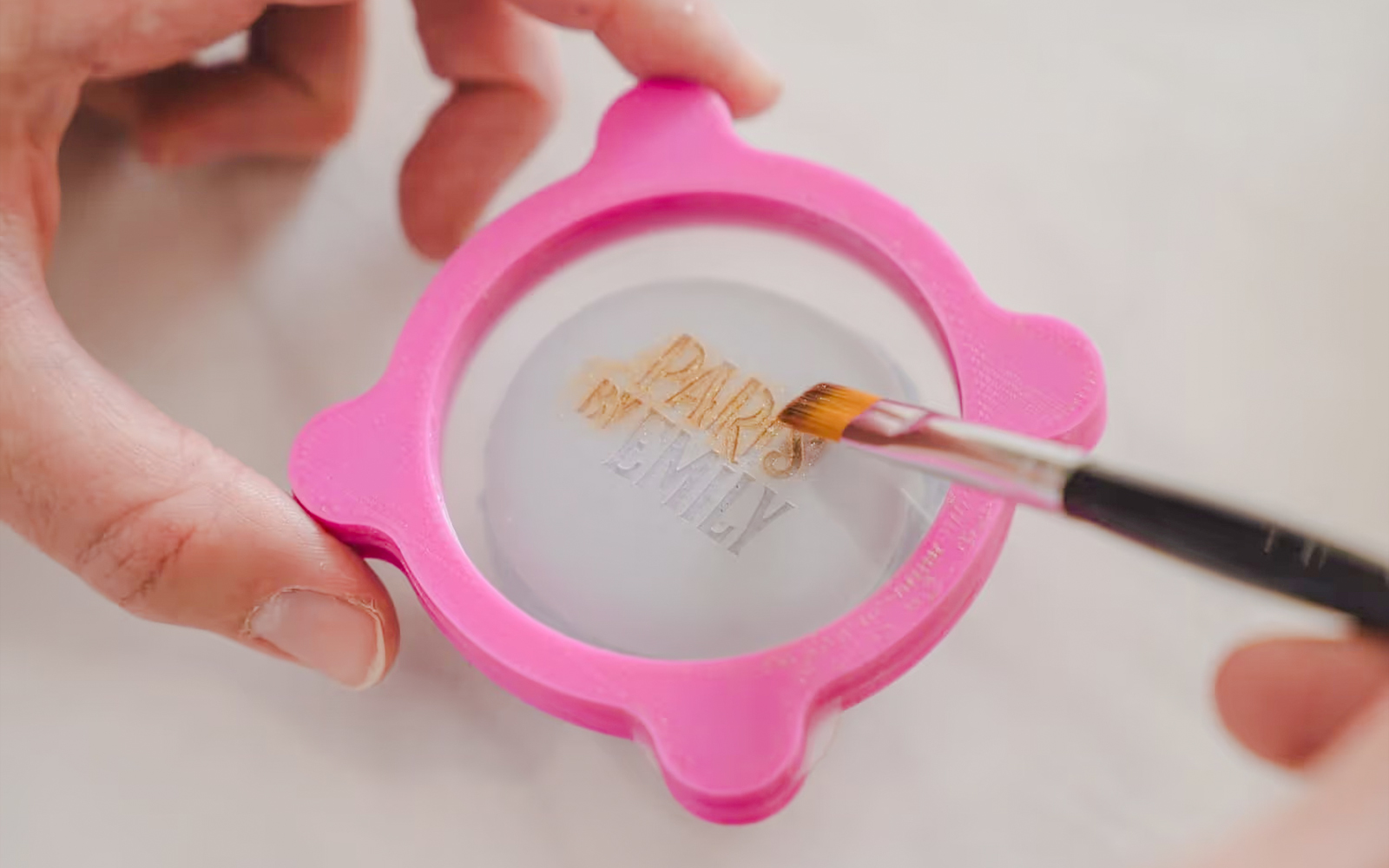 Macaron decoration at Emily in Paris workshop with pink stencil.