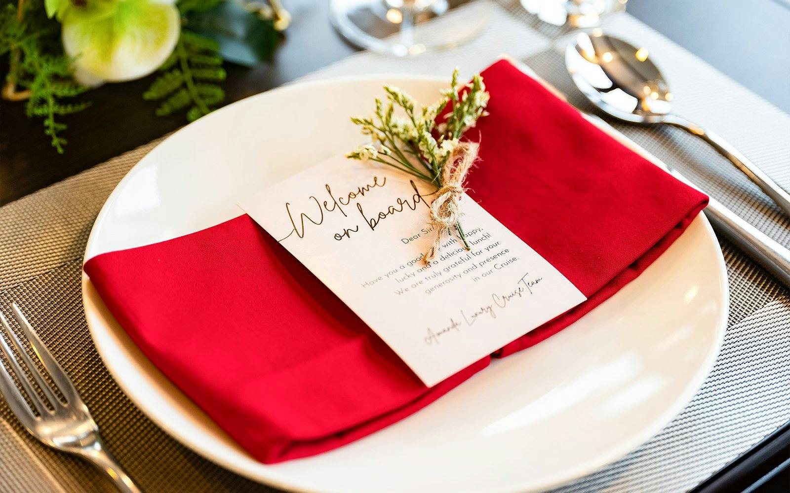 Dinner setting with welcome note on Amanda Luxury Cruise.