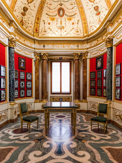 Art exhibits in a decorated room at the Uffizi Gallery, Florence, Italy.