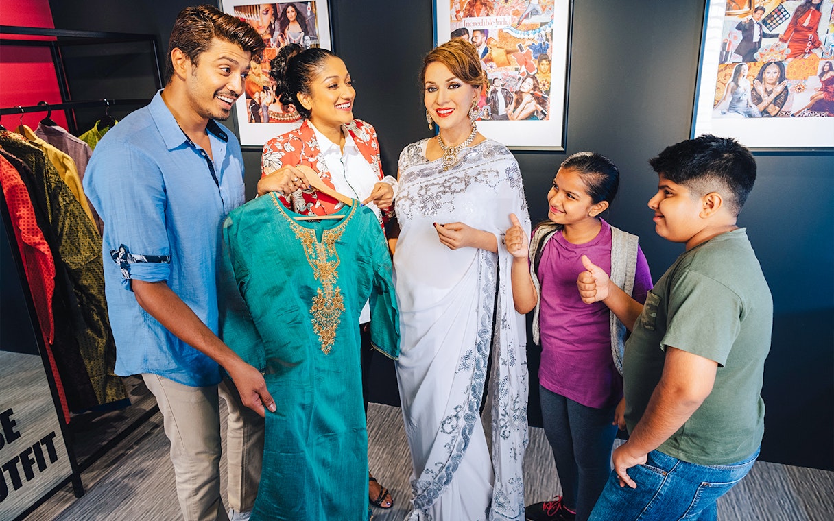Wax figures of famous personalities with visitors at Madame Tussauds Singapore.