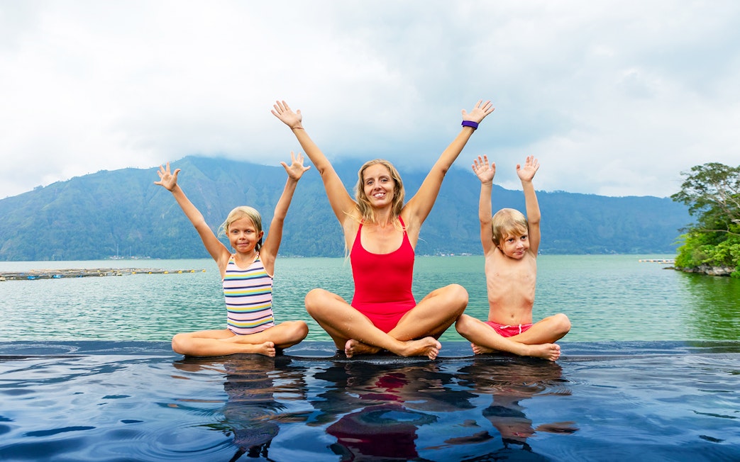 Family enjoying hot springs by Mount Batur, Bali.