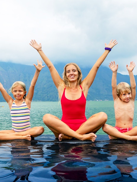 Family enjoying hot springs by Mount Batur, Bali.