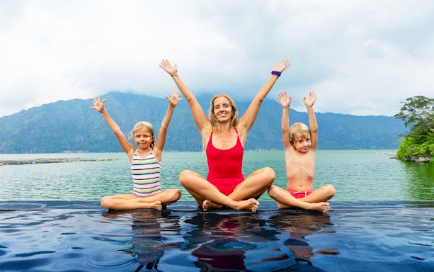 Family enjoying hot springs by Mount Batur, Bali.