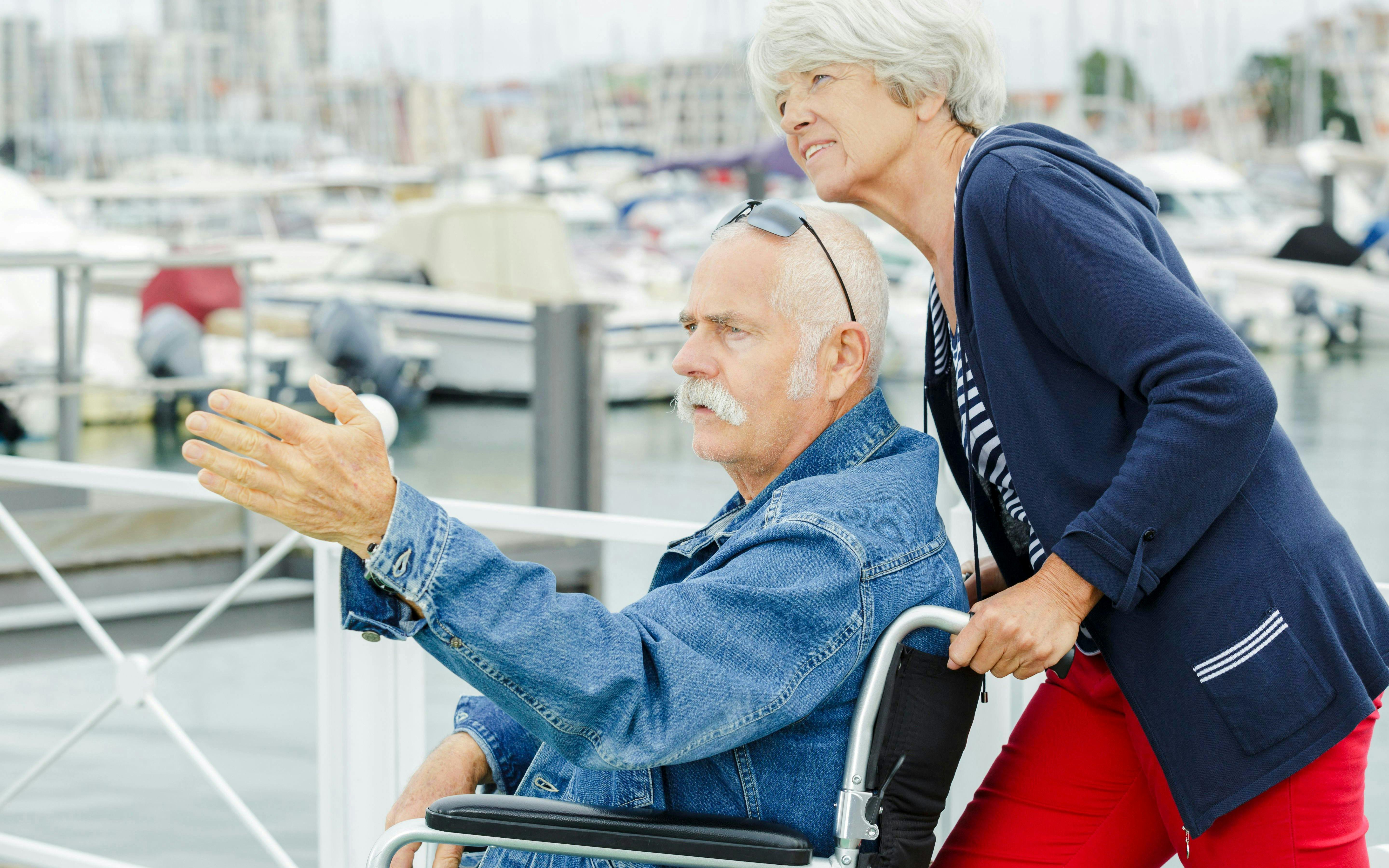 Elderly couple enjoying a view of the marina during a Mersailles cruise.