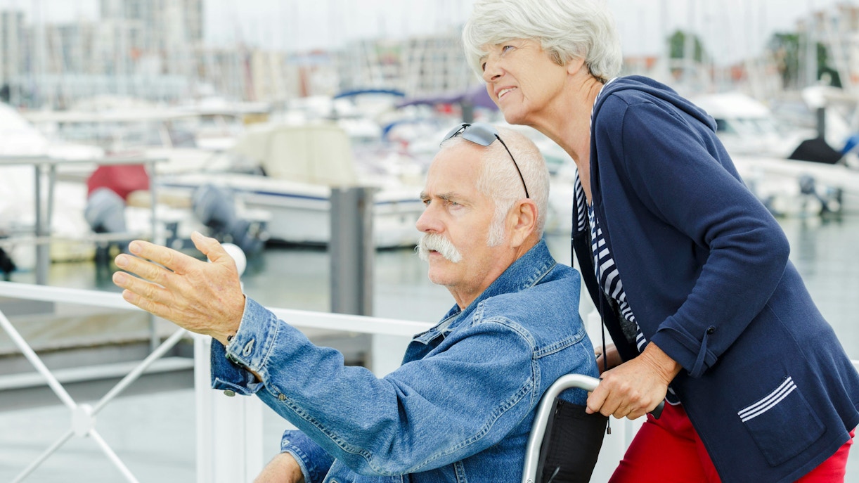 Elderly couple enjoying a view of the marina during a Mersailles cruise.