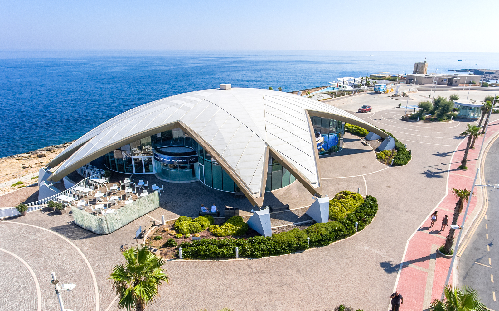 Aerial view of Malta National Aquarium with ocean backdrop.