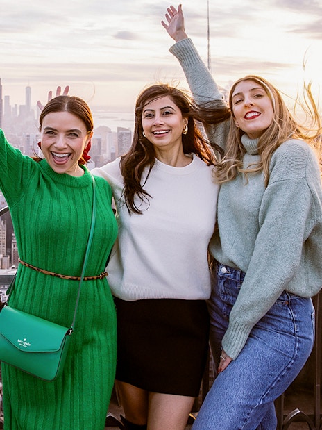 Visitors enjoying the view from Top of the Rock Observation Deck, New York City skyline in background.