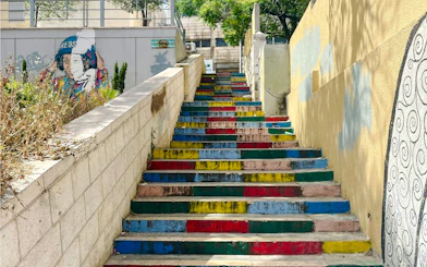 Colorful stairs on Rainbow Street, Amman, Jordan, with vibrant wall art.