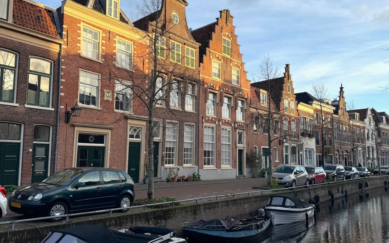Canal-side view of historic Dutch buildings in Haarlem during an open-boat canal cruise.