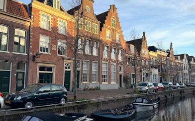 Canal-side view of historic Dutch buildings in Haarlem during an open-boat canal cruise.