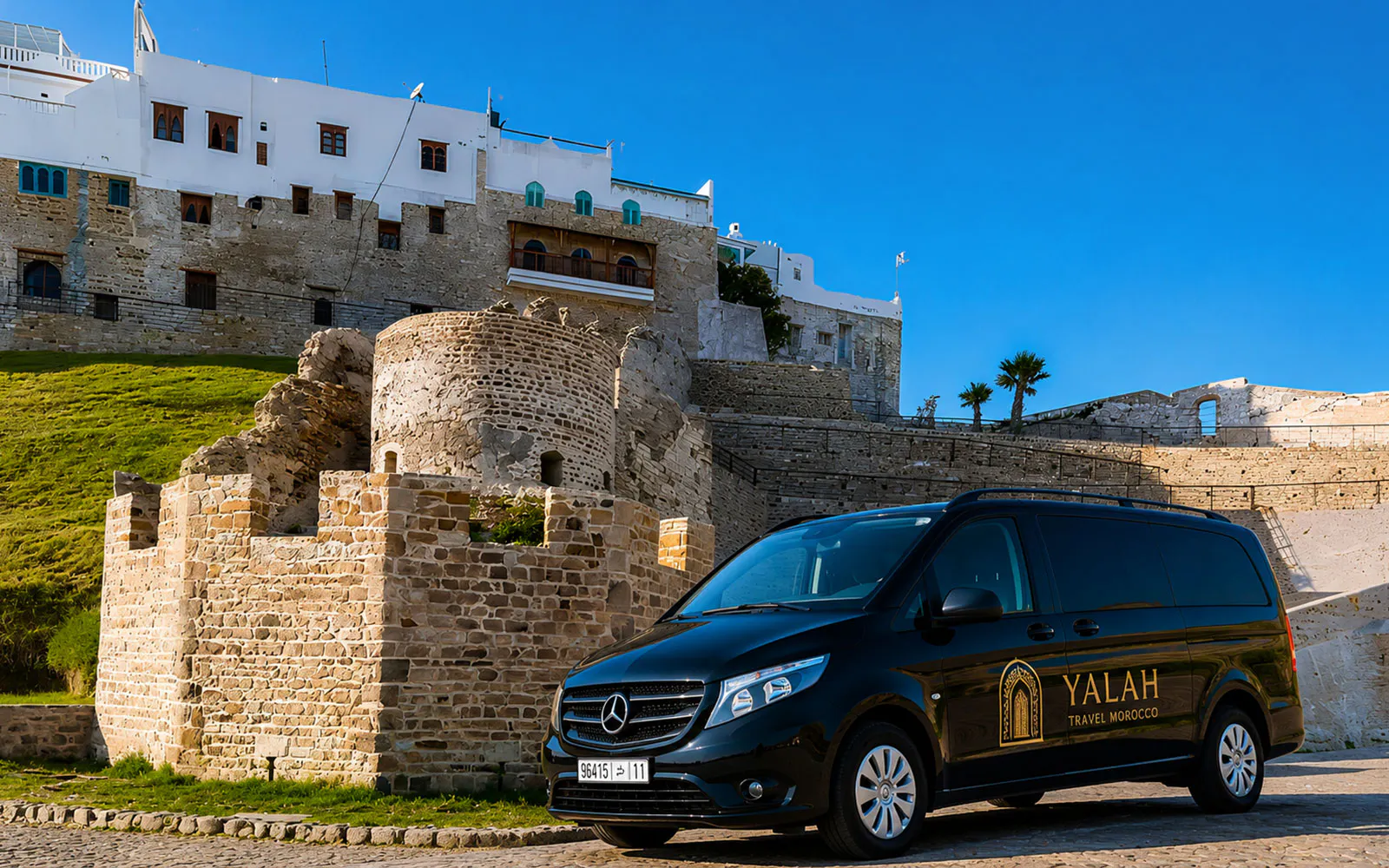 Tour van parked near historic Tangier Kasbah, Morocco.