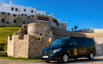 Tour van parked near historic Tangier Kasbah, Morocco.