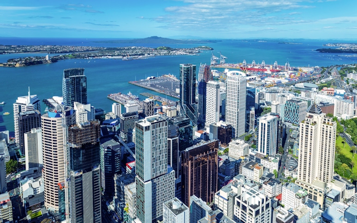 Auckland skyline and financial district viewed from Sky Tower with harbor in background.