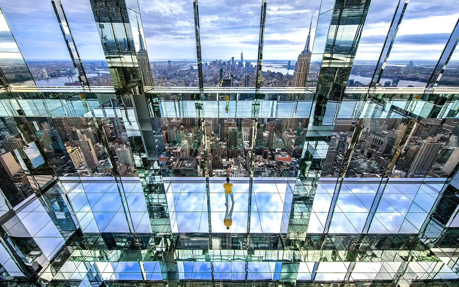 Observation deck view from SUMMIT One Vanderbilt, showcasing New York City skyline and mirrored reflections.